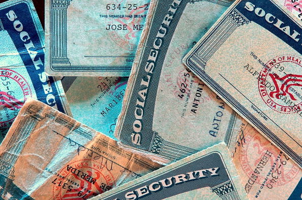 Fake Social Security cards, that have been seized but authorities, lay in a pile at the office of U.S. Immigration and Customs Enforcement in Charlotte, North Carolina. (Photo by Patrick Schneider/Charlotte Observer/MCT via Getty Images)
