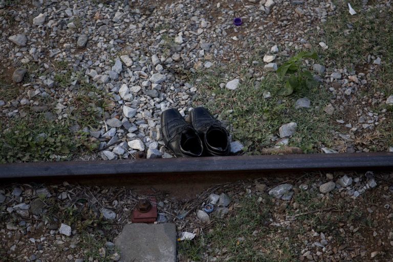 In this Saturday, July 12, 2014 photo, shoes are seen beside the train tracks in Ixtepec, Mexico. Migrants pay thousands of dollars per person for the illegal journey across thousands of miles in the care of smuggling networks that in turn pays off government officials, gangs operating on trains and drug cartels controlling the routes north. (AP Photo/Eduardo Verdugo)