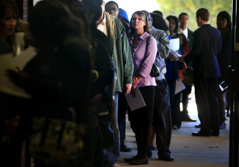 A long line of job seekers wait outside the Ferguson Community Center in Cordova, Tenn. The Labor Department reports on the number of Americans who applied for unemployment benefits in the last week on Dec. 26. (AP/The Commercial Appeal, Jim Weber)