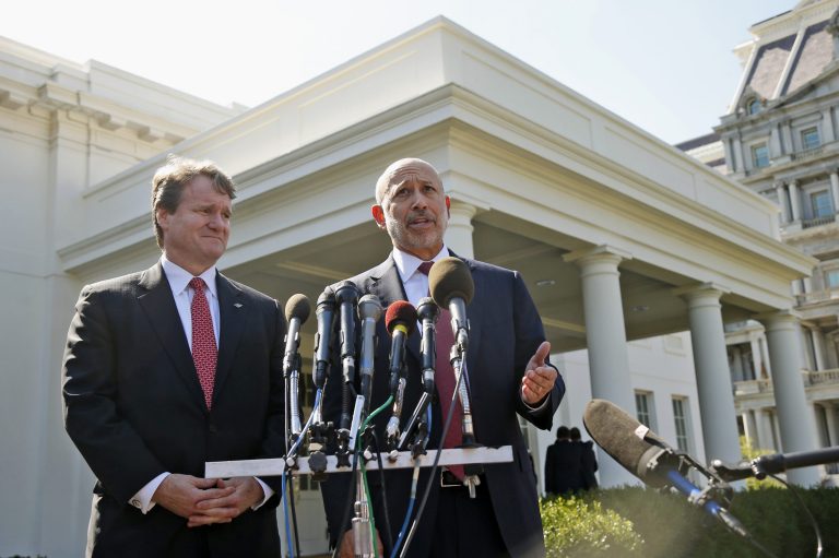 Goldman Sachs Chairman Lloyd Blankfein, right, accompanied by Bank of America CEO Brian Moynihan, speaks to reporters outside the White House in Washington on Wednesday. (AP Photo/Charles Dharapak)