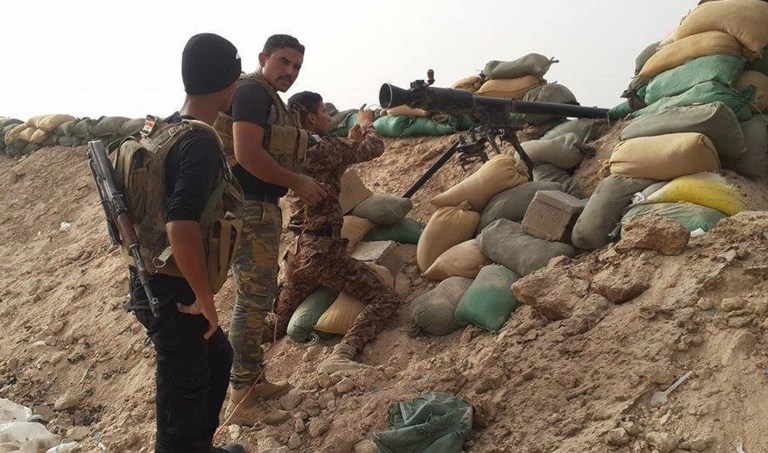 In this image taken Friday, May 29, 2015, Iraqi anti-terrorism forces battle with Islamic State group extremists as they defend their base against Islamic State group extremist attack outside Fallujah. (AP Photo)Â 