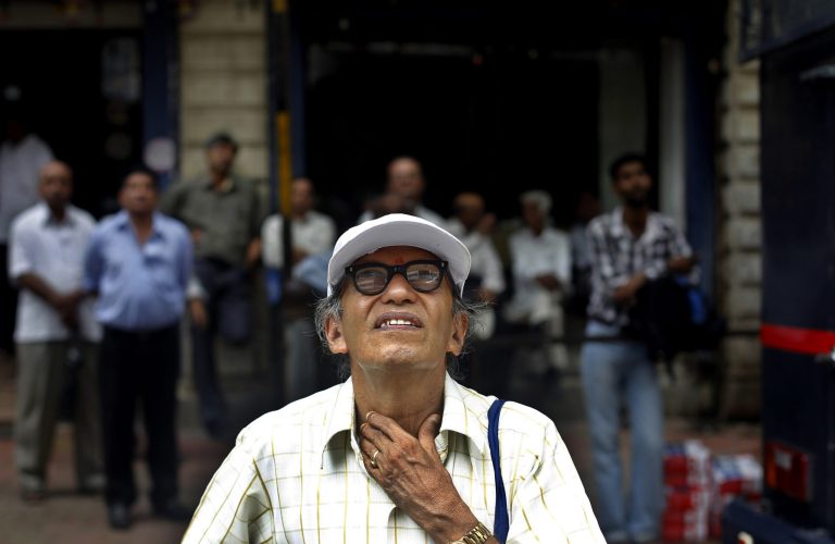  An Indian man watches a screen on the facade of the the Bombay Stock Exchange (BSE) building in Mumbai, India, Monday, June 18, 2012. India's central bank left its key interest rate unchanged Monday due to inflation concerns, thwarting hopes of a rate cut to kickstart flagging growth in Asia's third-largest economy. (AP Photo/Rafiq Maqbool)  