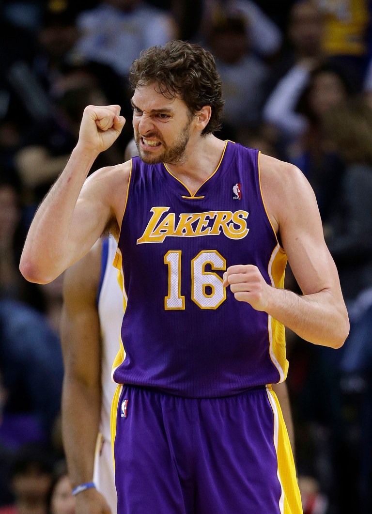   Los Angeles Lakers' Pau Gasol (16) celebrates after scoring against the Golden State Warriors during the second half of an NBA basketball game in Oakland, Calif., Saturday, Dec. 22, 2012. Los Angeles won in overtime 118-115. (AP Photo/Marcio Jose Sanchez)  