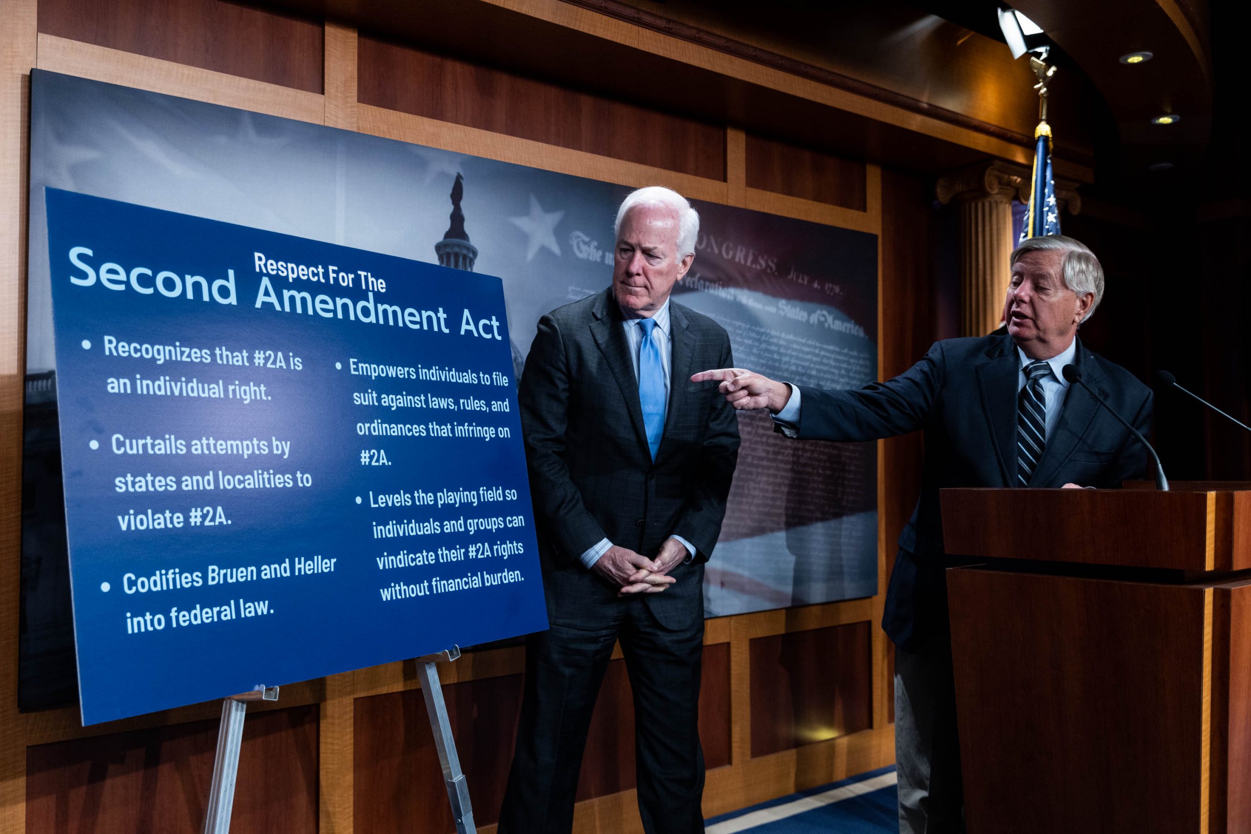 Sen. Lindsey Graham (R-SC) points toward a sign at a press conference on the introduction of the "Respect for the Second Amendment Act" on Capitol Hill on March 16, 2023, in Washington, D.C. The act intends to "codify Second Amendment rights for law abiding citizens." 