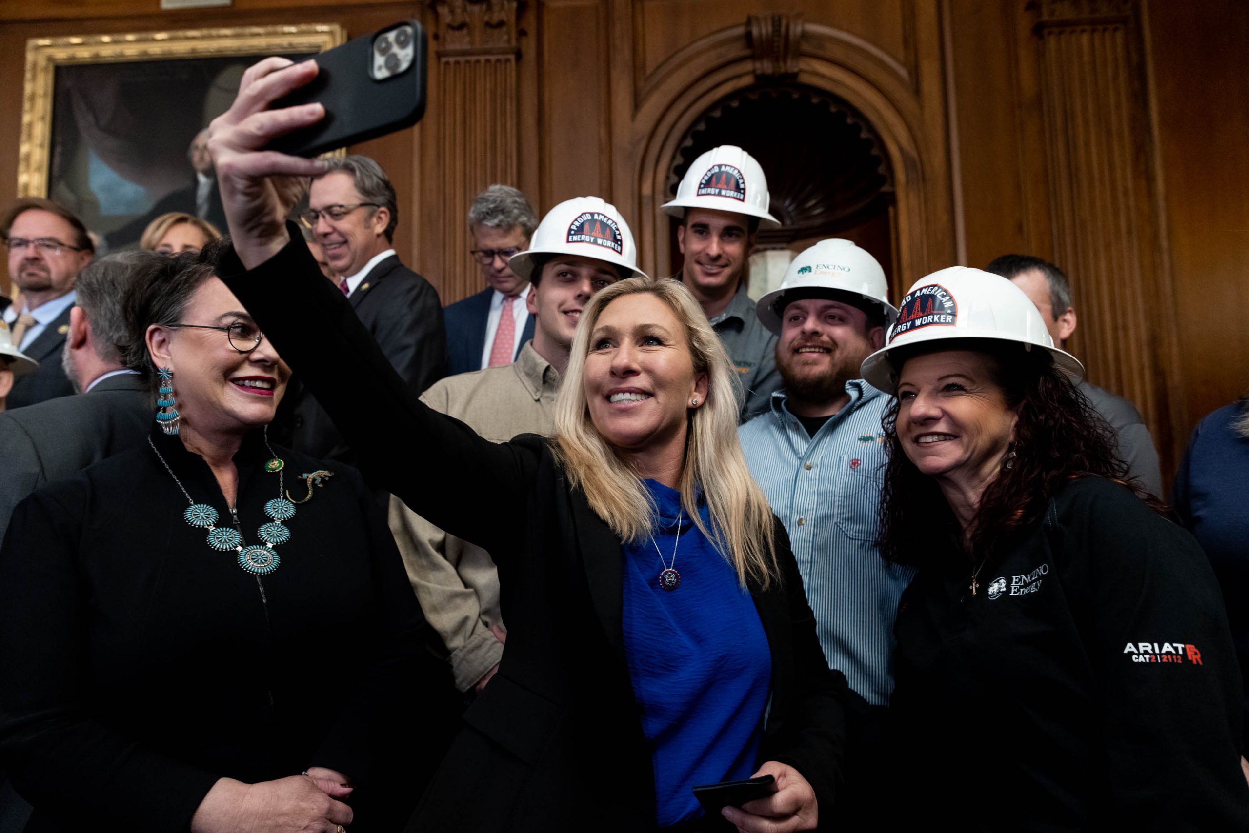 Rep. Marjorie Taylor Greene (R-GA) takes a selfie with energy sector workers at a news conference on the "Lower Energy Costs Act," on Capitol Hill, in Washington, D.C., on March 30, 2023.
