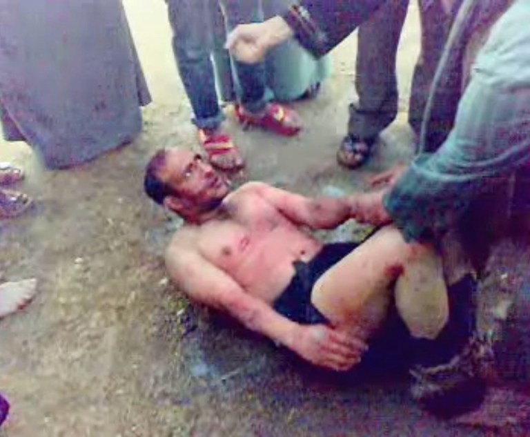 This image made from video, which has been authenticated based on its contents and other AP reporting shows a man, bound by his feet, surrounded by villagers as he asks to be taken to a hospital, before he was beaten and then tied to a tree until he died in the northern Sharqiya province in Egypt, Thursday, March 21, 2013. Egyptian witnesses and officials say villagers beat the man to death after catching him trying to steal a car in a new case of vigilante violence. A number of recent lynchings or attempted lynchings have raised worries over an increasing breakdown of security, adding a new challenge to Egypt's government. A security official says dozens of villagers in Ezbat el-Gindy in the northern Sharqiya province caught the man trying to steal a car at gunpoint Thursday.(AP Photo)