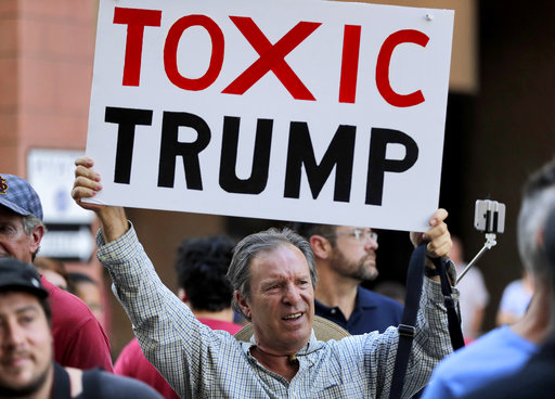 Some anti-Trump signs also addressed racially charged violence in Charlottesville, Va., earlier this month and Trump's controversial comments blaming 