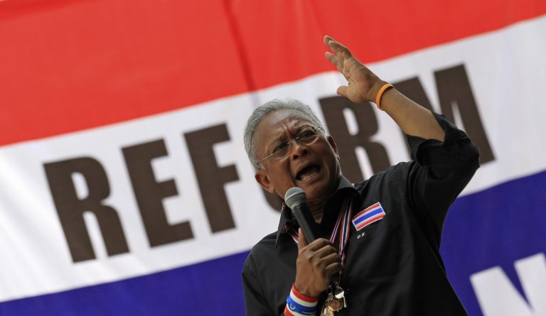 Anti-government protest leader Suthep Thaugsuban speaks to supporters in Bangkok, Thailand, Friday, Feb. 28, 2014. The leader of Thailand's anti-government protest movement said Thursday he is willing to negotiate to end the country's political crisis, if Prime Minister Yingluck Shinawatra is willing to talk with him live, one-to-one, on every national television station. (AP Photo/Sakchai Lalit)