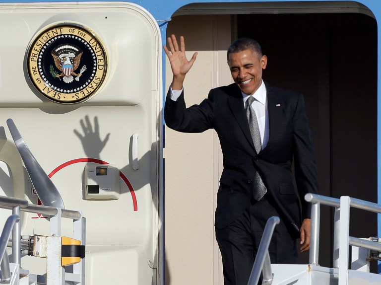 President Barack Obama waves as he arrives at Miami International Airport, Friday, Nov. 8, 2013, in Miami. President Obama will be participating in fund raising events during his visit to Miami. (AP Photo/Alan Diaz)