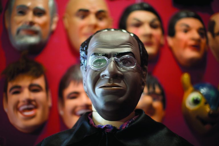 In this Jan. 21, 2013 photo, a Carnival mask in the likeness of Brazilian Supreme Court Justice Joaquim Barbosa is displayed on a mannequin at the Condal factory in Sao Goncalo, near Rio de Janeiro, Brazil. Condal is Brazil's oldest and most productive mask factory that is run by Olga Valles, a family business started in 1958. Barbosa, born into poverty, became the first black judge in the nation's top court when he took office in 2003. Barbosa went on to make a name for himself when he presided over a wide-ranging political corruption trial involving a cash-for-votes scheme. Now, average Brazilians are honoring him during Carnival by buying his mask in droves, said Valles. Brazil's annual five-day extravaganza begins Friday. (AP Photo/Felipe Dana)