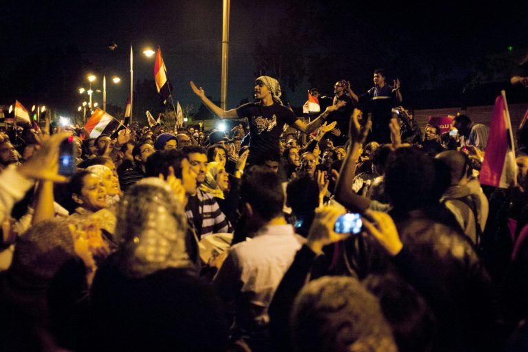   Egyptian protesters chant anti Muslim Brotherhood slogans during a demonstration in front of the presidential palace in Cairo, Egypt, Tuesday, Dec. 4, 2012. A protest by tens of thousands of Egyptians outside the presidential palace in Cairo turned violent on Tuesday as tensions grew over Islamist President Mohammed Morsi's seizure of nearly unrestricted powers and a draft constitution hurriedly adopted by his allies. (AP Photo/Nasser Nasser)  