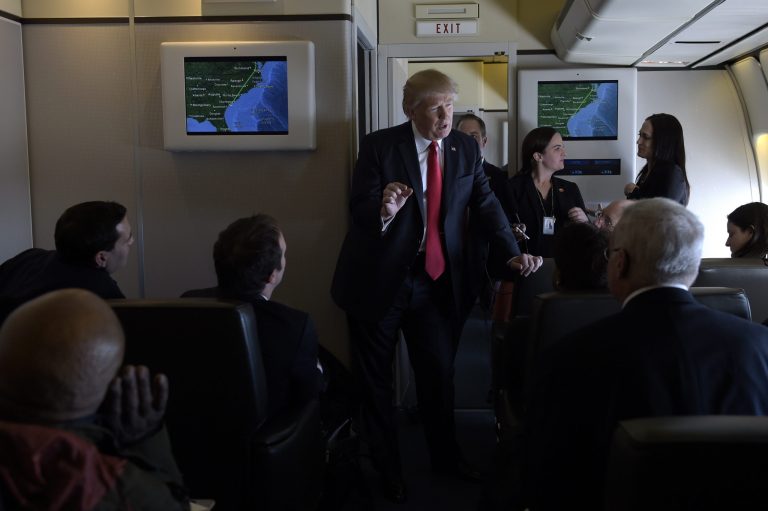 President Donald Trump speaks to reporters on Air Force One while traveling to Palm Beach International Airport in West Palm Beach, Fla., Friday, Feb. 3, 2017. Trump is spending the weekend at Mar-a-Lago. (AP Photo/Susan Walsh)