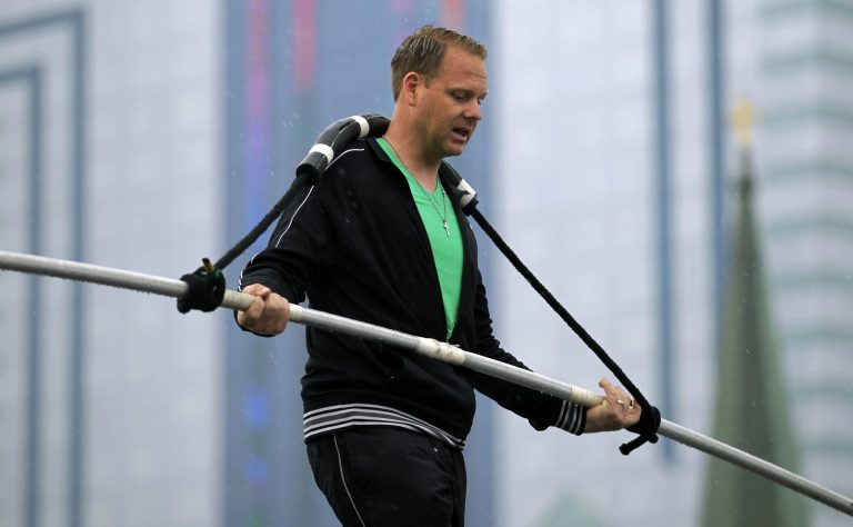   FILE - This May 16, 2012 photo shows Nik Wallenda performing a walk on a tightrope in the rain during training for his walk over Niagara Falls in Niagara Falls, N.Y. Wallenda can't visit a new place without envisioning a wire strung high above his head: Linking buildings, landmarks, nations. Even as a 6-year-old at Niagara Falls with his parents, he pictured walking a tightrope over the raging, whitewater maw. Now 33, he's ready to live out that childhood fantasy when he attempts Friday, June 15, 2012 to become the first person ever to walk a tightrope directly over the brink of Niagara Falls. (AP Photo/David Duprey)  