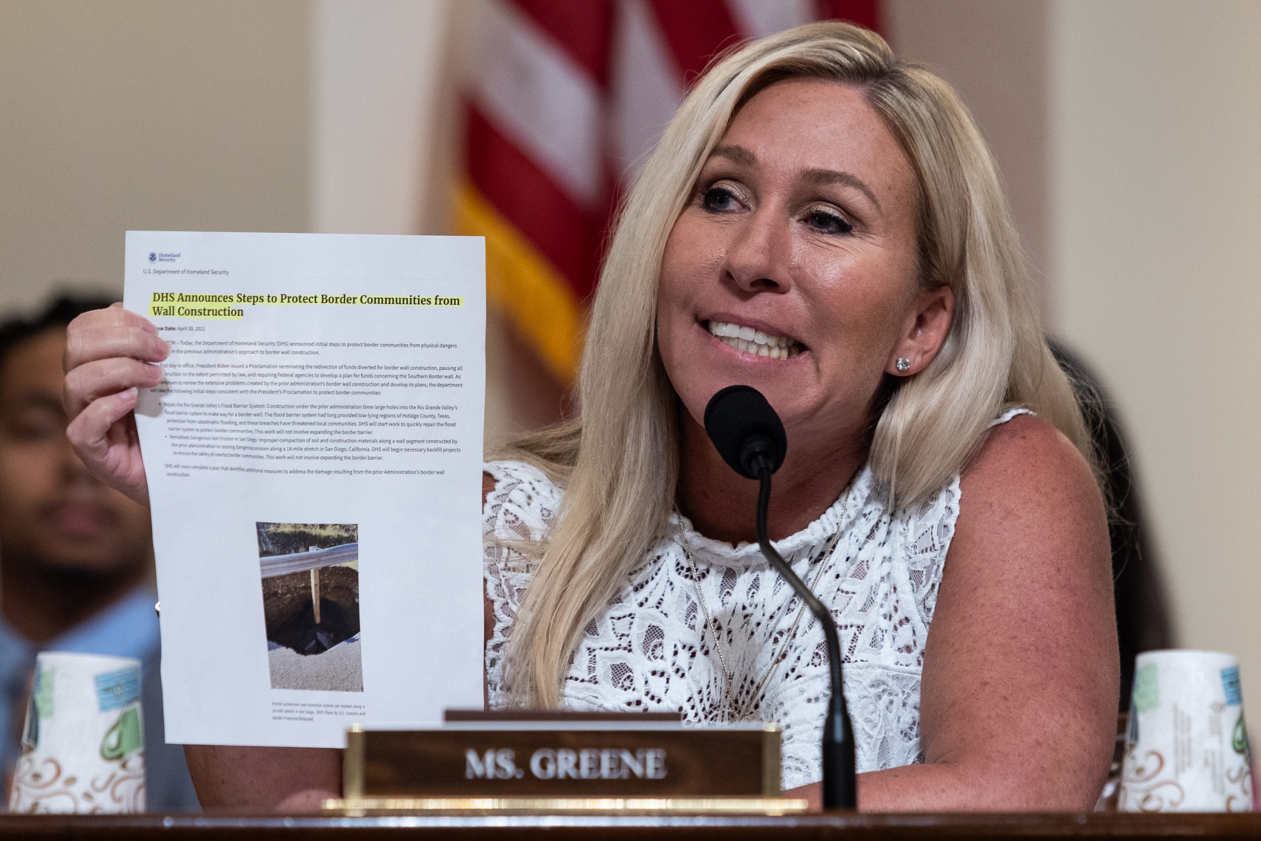 Rep. Marjorie Taylor Greene holds up a Department of Homeland Security press release entitled "DHS Announces Steps to Protect Border Communities from Wall Construction" at a House Homeland Security Committee Hearing on Capitol Hill, Tuesday, July 18, 2023. In her comments, Greene said, "I don't know who wrote this but they probably should have been fired."