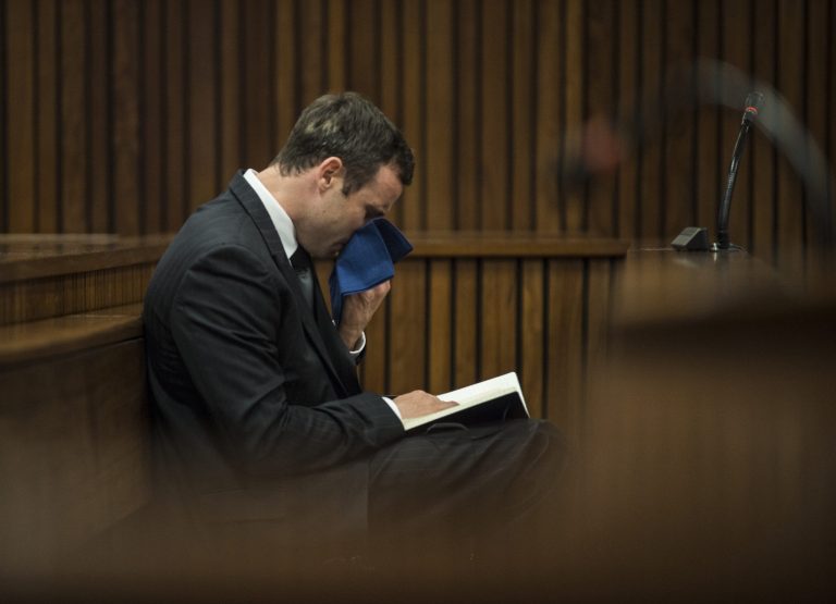 Oscar Pistorius reacts as he listens to the state prosecutor summarizing evidence at his murder trial in Pretoria, South Africa, Thursday, Aug. 7, 2014. The chief prosecutor said Thursday the double-amputee athlete's lawyers have floated more than one theory in a dishonest attempt to defend against a murder charge for his killing of girlfriend Reeva Steenkamp.  (AP Photo/Mujahid Safodien, Pool)