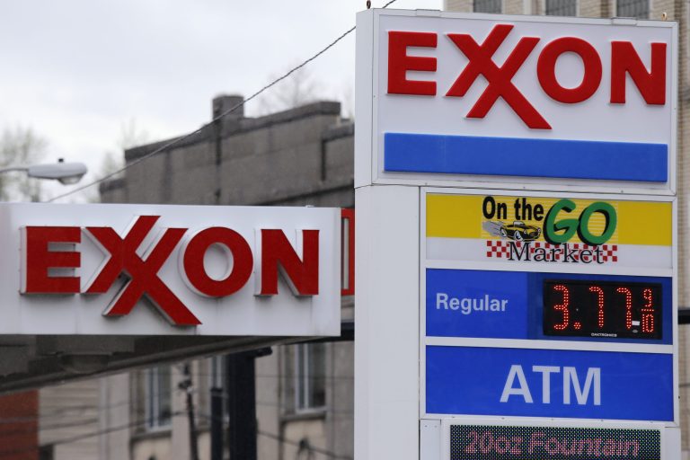 This April 29, 2014 photos shows Exxon signage at a mini-mart in Dormont, Pa. Exxon Mobil reports quarterly earnings on Thursday, May 1, 2014. (AP Photo/Gene J. Puskar)