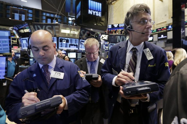 Traders Fred Demarco, left, and Joseph Chirico, right, work on the floor of the New York Stock Exchange, Thursday, June 18, 2015. (AP Photo/Richard Drew)