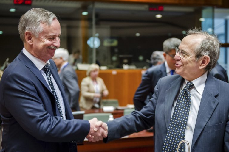 Italian Finance Minister Pier Carlo Padoan, right, greets Vice President of the European Commission Siim Kallas during a EU finance ministers meeting at the European Council building in Brussels, Tuesday, July 8, 2014. (AP Photo/Geert Vanden Wijngaert)