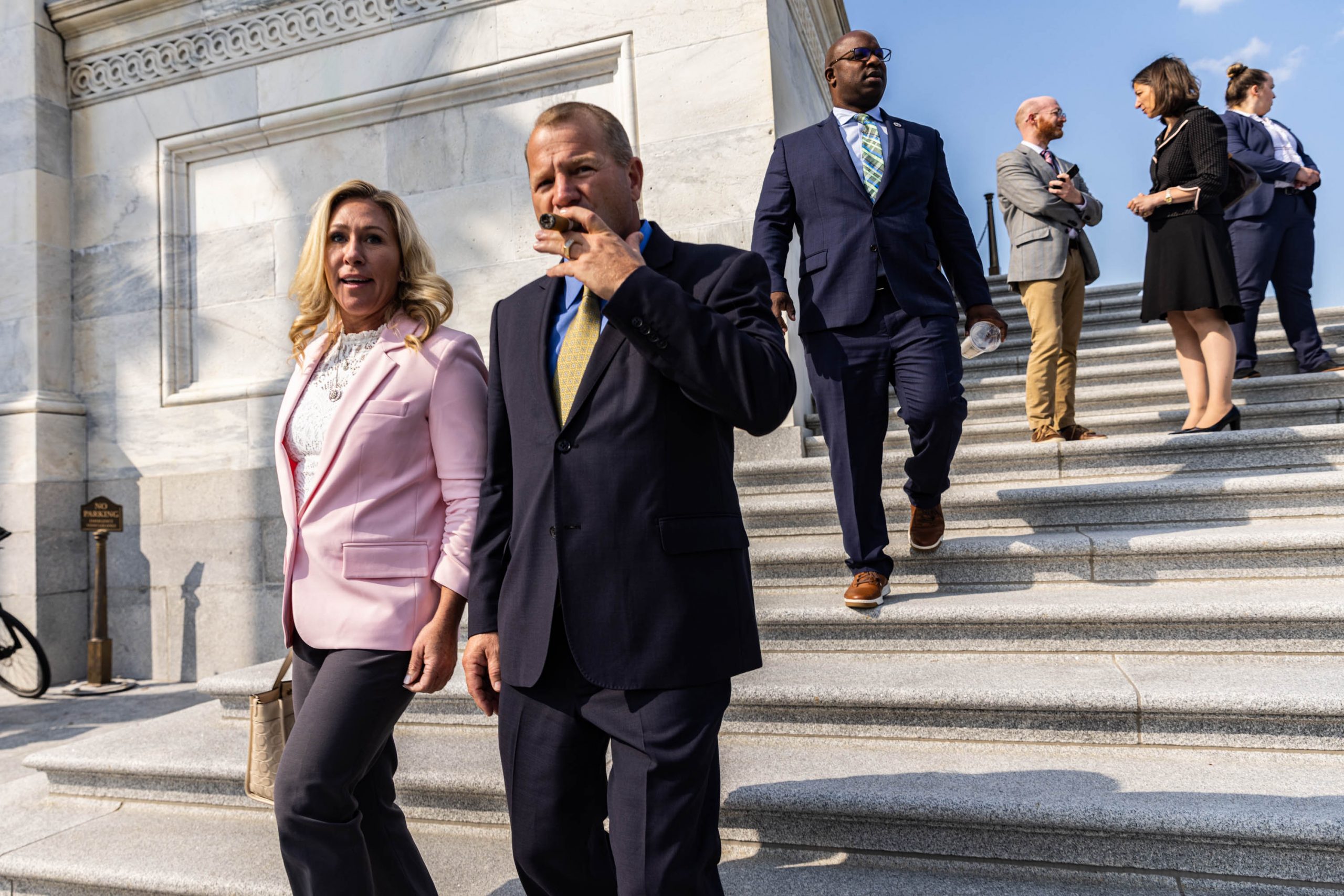 Marjorie Taylor Greene (R-GA) and Troy Nehls (R-TX) walk down the House steps after the last votes of the week at the Capitol, Sept. 15, 2022, in Washington, D.C.