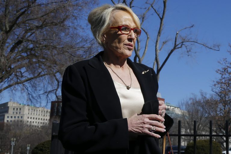 Arizona Gov. Jan Brewer walks toward the West Wing of the White House in Washington on Monday after the National Governors Association met with President Obama. (AP Photo/Charles Dharapak)