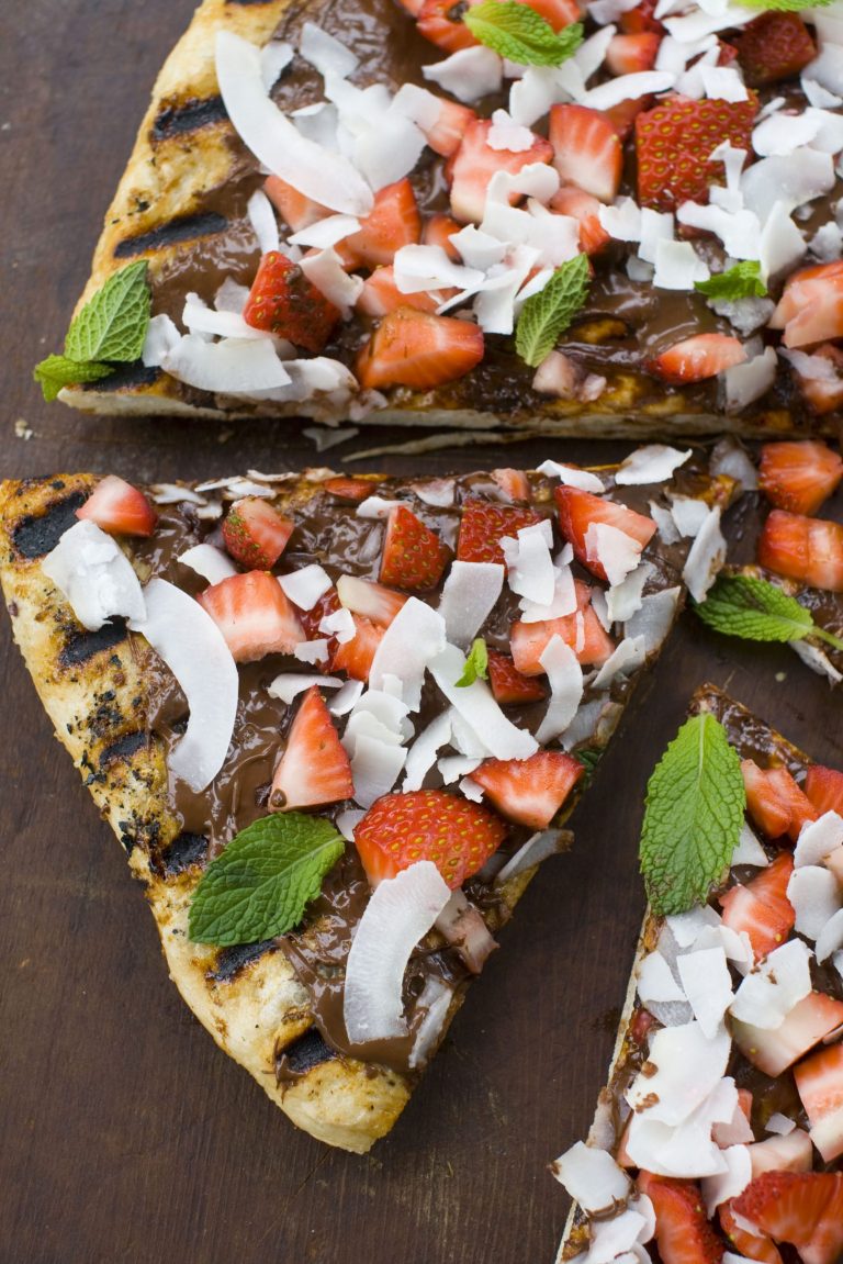   This image taken on May 14, 2012 in Concord, N.H., shows a grilled dessert pizza topped with flaked coconut, fresh strawberries and chocolate bits. (AP Photo/Matthew Mead)  
