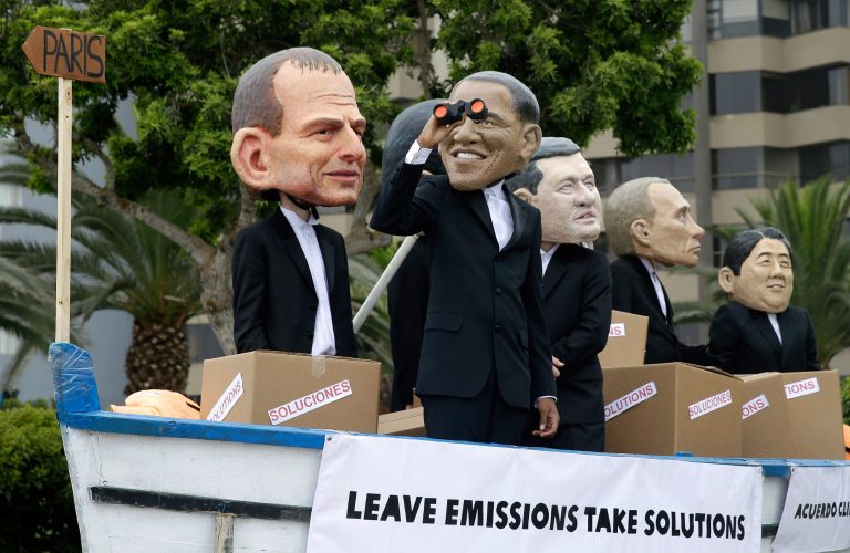 Environmental activists in a mock boat perform wearing puppet heads representing leaders, from left, Australia's Prime Minister Tony Abbott, President Barak Obama, Canada's Prime Minister Stephen Harper, Russia's President Vladimir Putin and Japan's Prime Minister Shinzo Abe during the Climate Change Conference COP20 in Lima Peru, Friday.(AP Photo/Martin Mejia)