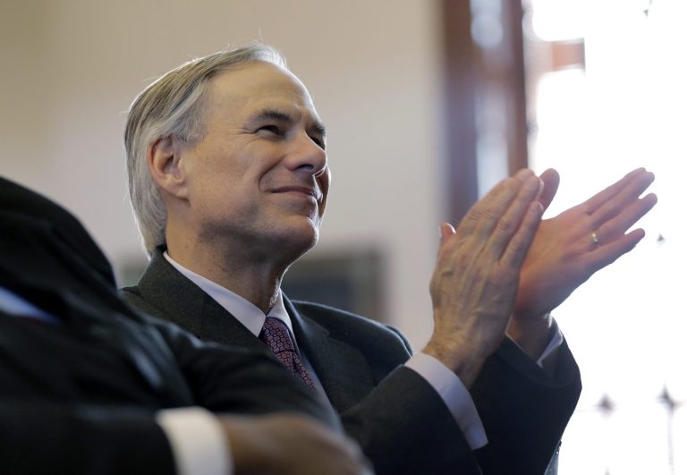 Texas Gov.-elect Greg Abbott applauds Gov. Rick Perry during a farewell speech to a joint session of the Texas Legislature, Thursday, Jan. 15, 2015, in Austin, Texas. (AP/Eric Gay)