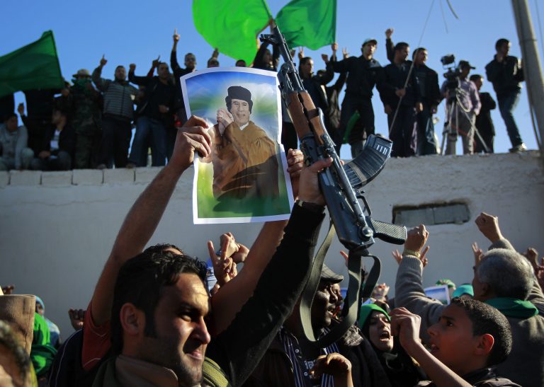In this Image taken during an organized trip by the Libyan authorities, men demonstrate their support for Libyan leader Moammar Gadhafi in Tripoli, Sunday March 20, 2011. (AP Photo/Jerome Delay)