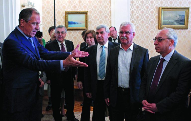 Russian Foreign Minister Sergey Lavrov, left, welcomes a delegation headed by a leader of the Syrian National Council (SNC), Abdulbaset Sieda, right, in Moscow, Russia, Wednesday, July 11, 2012. (AP Photo/Misha Japaridze)