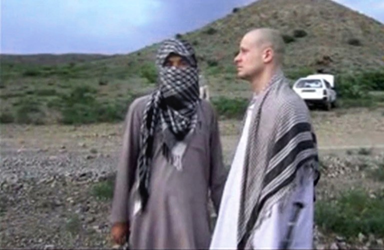 FILE - In this file image taken from video obtained from Voice Of Jihad Website, which has been authenticated based on its contents and other AP reporting, Sgt. Bowe Bergdahl, right, stands with a Taliban fighter in eastern Afghanistan. The Taliban said Friday, June 6, 2014, that Bergdahl was treated well during the five years they held him captive and was even allowed to play soccer with the men holding him. (AP Photo/Voice Of Jihad Website via AP video, File)