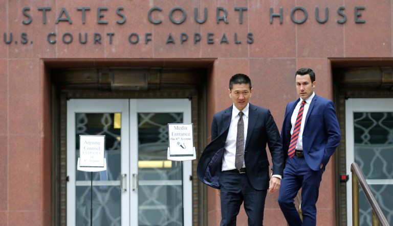 Hawaii Attorney General Doug Chin, left, walks with Joshua Wisch, right, special assistant to the attorney general, Monday, May 15, 2017, outside a federal courthouse in Seattle. (AP Photo/Ted S. Warren)