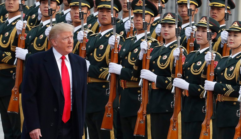 Trump's breakthroughs on North Korea and Southeast Asia trade policy had to compete with news of Republicans' electoral woes and Moore's underage sex scandal back in Washington, however. (AP Photo/Andy Wong)