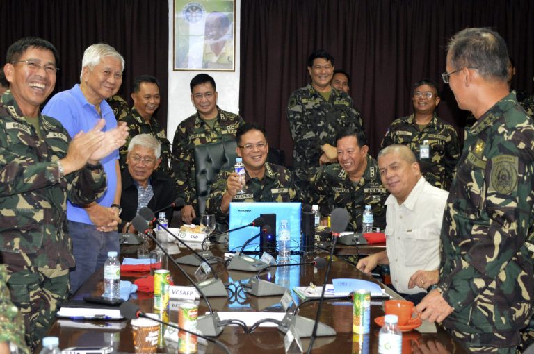 In this photo released by the Armed Forces of the Philippines Public Affairs Office, Philippine Military Chief Gen. Gregorio Catapang, center, reacts after learning about the safe repositioning of Filipino peacekeepers in Golan Heights as they monitor the situation with Philippine Foreign Affairs Secretary Albert Del Rosario, second left, Philippine National Defense Secretary Voltaire Gazmin, third from left seated, at Camp Aguinaldo military headquarters in suburban Quezon city, Philippines on Saturday, Aug. 30, 2014. Catapang said more than 70 Filipino peacekeepers have escaped from two areas in the Golan Heights that came under attack by Syrian rebels. (AP Photo/Armed Forces of the Philippines Public Affairs Office)