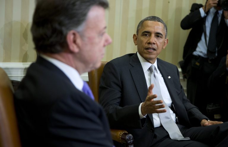 President Barack Obama meets with Colombian President Juan Manuel Santos in the Oval Office of the White House in Washington, Tuesday, Dec. 3, 2013. President Barack Obama says there has been a 20 percent increase in trade between the U.S. and Colombia since the two countries signed a free trade agreement during his first term. The two leaders are holding talks focused on growing the economic relationship between their countries.   (AP Photo/ Evan Vucci)