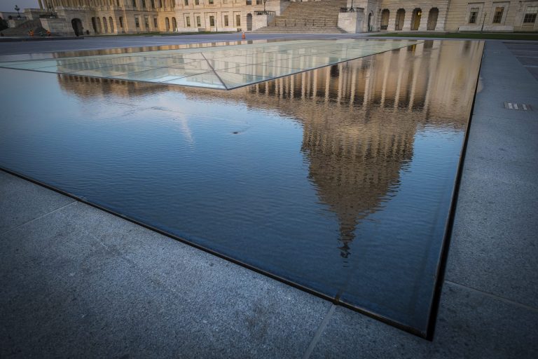 The U.S. Capitol dome is reflected in the pool around the Capitol visitors center earlier this year. (AP Photo/J. David Ake)