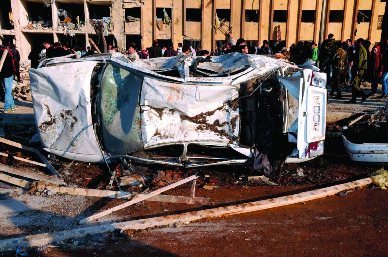 In this photo released by the Syrian official news agency SANA, Syrian people gather at the site after an explosion hit a university in Aleppo, Syria, Tuesday, Jan. 15, 2013. Two explosions struck the main university in the northern Syrian city of Aleppo on Tuesday, causing an unknown number of casualties, state media and anti-government activists said. There were conflicting reports as to what caused the blast at Aleppo University, which was in session Tuesday. (AP Photo/SANA)