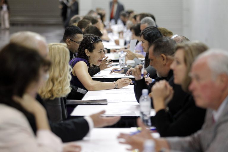 In this June 13 file photo, job seekers have their resumes reviewed at a job fair expo in Anaheim, Calif.  (AP Photo/Jae C. Hong, File)