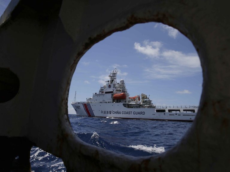 FILE - In this March 29, 2014 file photo, a China Coast Guard vessel attempts to block a Philippine government vessel as the latter tries to enter the China Second Thomas Disputed Shoals (local name Ayungin Shoal) to replace Philippine troops and resupply provisions off the South China Sea.  Despite U.S. and Asian calls for self-restraint and new impetus for the resolution of territorial disputes involving China, a high-profile Asian security summit ended Sunday, Aug. 10, 2014, where it began, with no solution of the rifts in sight. (AP Photo/Bullit Marquez, File)