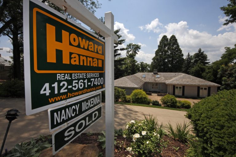   In this Tuesday, July 23, 2013, photo, a sold sign hangs outside a home in Mt. Lebanon, Pa. The National Association of Realtors reports on a measure of the number of Americans who signed contracts to buy homes in July on Wednesday, Aug. 28, 2013. (AP Photo/Gene J. Puskar)  