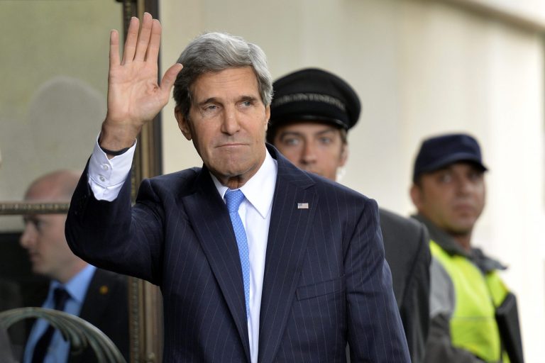 U.S. Secretary of State John Kerry waves as he arrives in Geneva, Switzerland, Thursday, Sept. 12, to test the seriousness of a Russian proposal to secure Syria's chemical weapons. (AP/Keystone, Martial Trezzini)