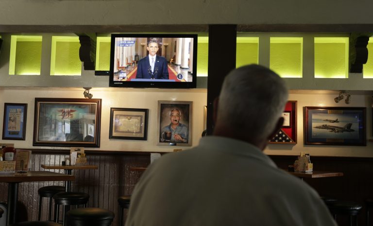   John Merry watches President Barack Obama deliver a speech about relations with Syria from McP's Pub, Tuesday, Sept. 10, 2013, in Coronado, Calif. Obama said in a nationally televised address Tuesday night that recent diplomatic steps offer 