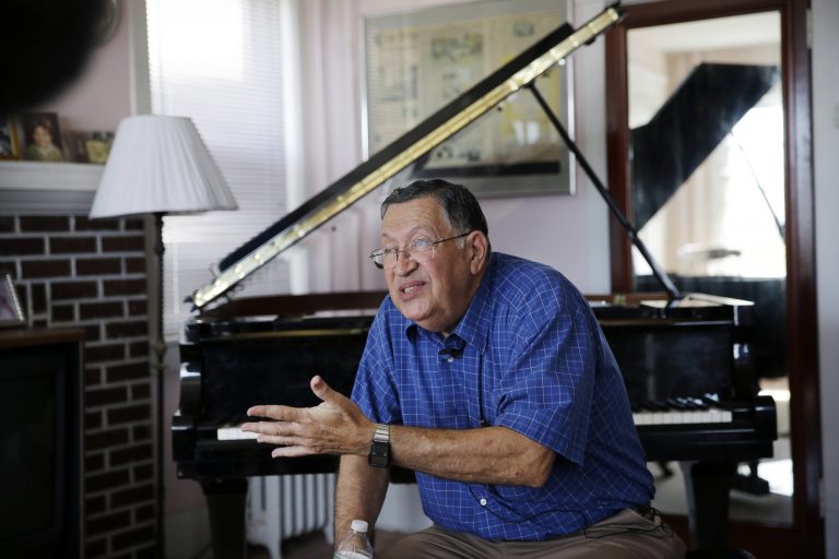 Charlie Birnbaum, 67, sits with his piano in the home where he was raised Wednesday, Aug. 27, 2014, in Atlantic City, N.J. Birnbaum, who turned his love for the piano into a job tuning pianos in Atlantic City's casinos, is fighting the state's attempt to take his home in the shadows of the failed Revel Casino Hotel through eminent domain. The Casino Reinvestment Development Authority wants to take the home where Birnbaum was raised, and where his mother was killed, even though the casino is closing next week. (AP Photo/Mel Evans)