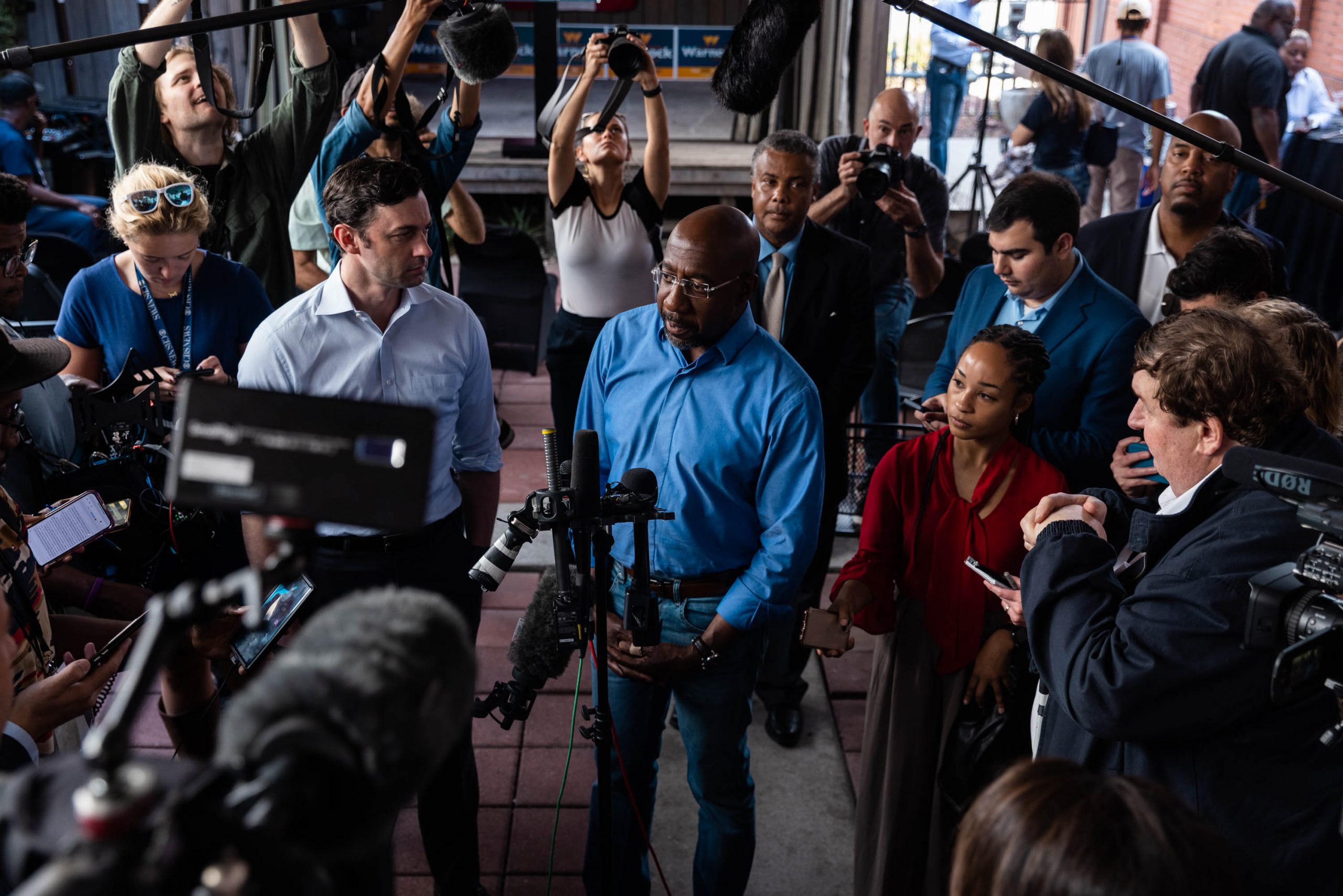 Sen. Raphael Warnock takes questions from the media following a campaign rally in Macon, Georgia, on November 7.