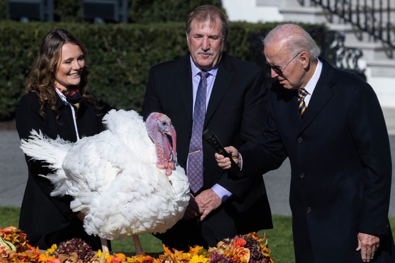 President Joe Biden holds the mic to Chocolate, the national Thanksgiving turkey, on the South Lawn of the White House in Washington on Monday, Nov. 21, 2022. 
