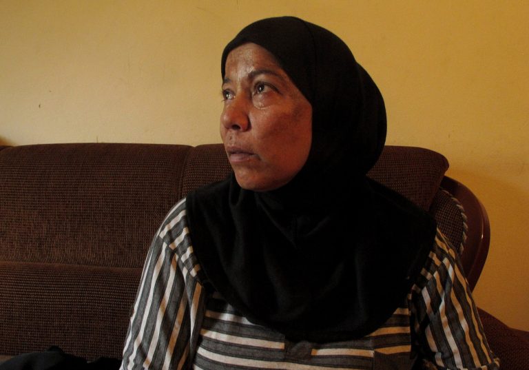 In this July 14, 2014 photo, Syrian refugee Umm Jamil looks on at her house in Halba town, northern Lebanon. Jamil, who takes care of her 19-year-old disabled son, said she was falsely accused of prostitution after Lebanese police confused her for another suspected prostitute in her building. Her brief detention left her feeling humiliated and wanting to leave Lebanon, where she said Syrian women are often seen as being sexually promiscuous. (AP Photo/Diaa Hadid)