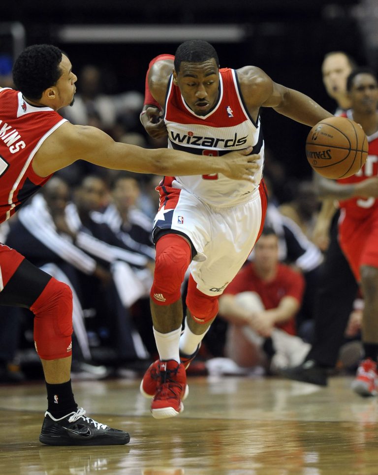 Richard Lipski/AP
John Wall played his first game of the season Saturday as the Wizards beat the Hawks.