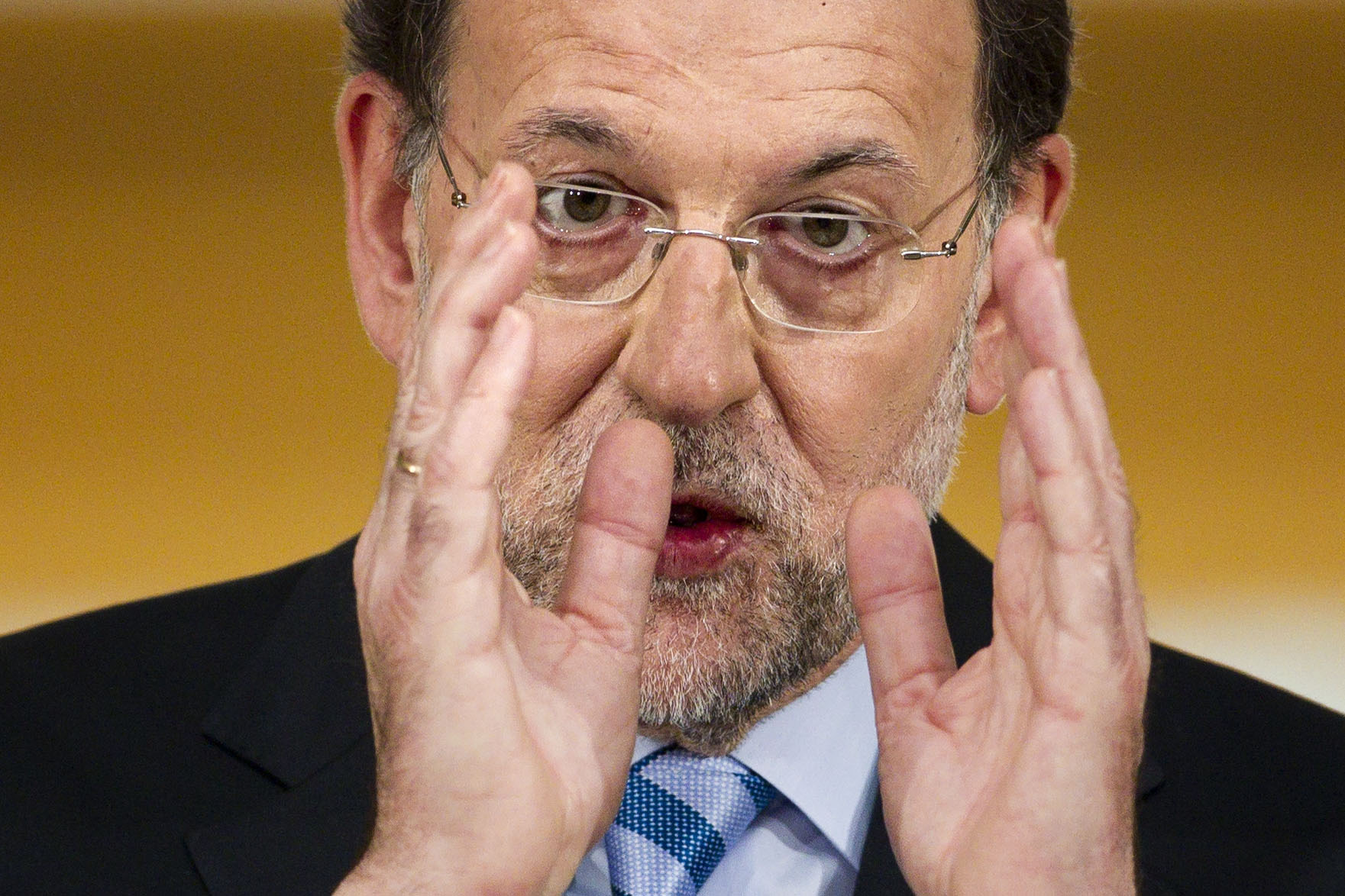 Spain relieved, angry over humiliating bank rescue