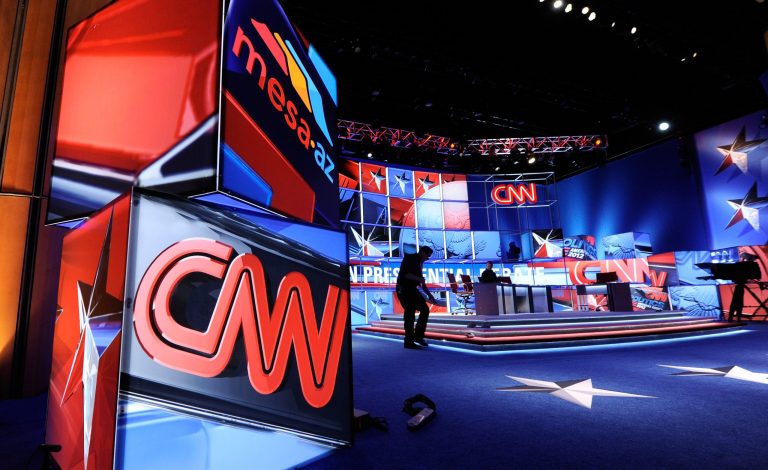 Workers prepare the stage for a debate sponsored by CNN and the Republican Party of Arizona at the Mesa Arts Center between Republican presidential candidates U.S. Rep. Ron Paul (R-TX), former U.S. Sen. Rick Santorum, former Massachusetts Gov. Mitt Romney and former Speaker of the House Newt Gingrich on February 22, 2012 in Mesa, Arizona. (Photo by Ethan Miller/Getty Images)