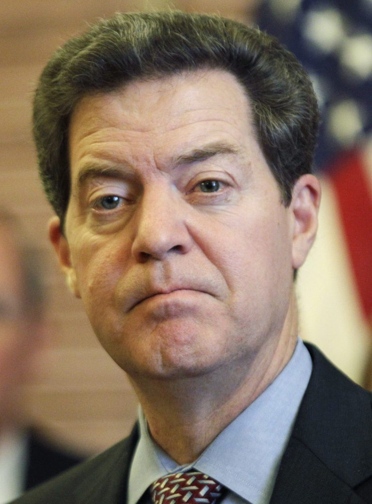   FILE - In this Jan 9, 2012 file photo, Kansas Gov. Sam Brownback listens to a reporter's question during a news conference in his Statehouse office in Topeka, Kan. Republicans set out a bold conservative agenda after taking control of state capitols across the Midwest and South in the last general election. But after a series of notable achievements last year, the largest Republican wave in statehouses since the Great Depression now is splintering and action on key issues is stalled despite little meaningful opposition from outnumbered Democrats. (AP Photo/Orlin Wagner)  