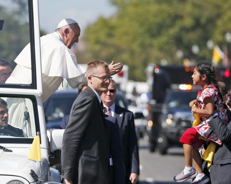 Pope Francis reaches to give a blessing to Sophie Cruz, 5, from suburban Los Angeles, during a parade in Washington, Wednesday, Sept. 23, 2015. (AP Photo/Alex Brandon, Pool)